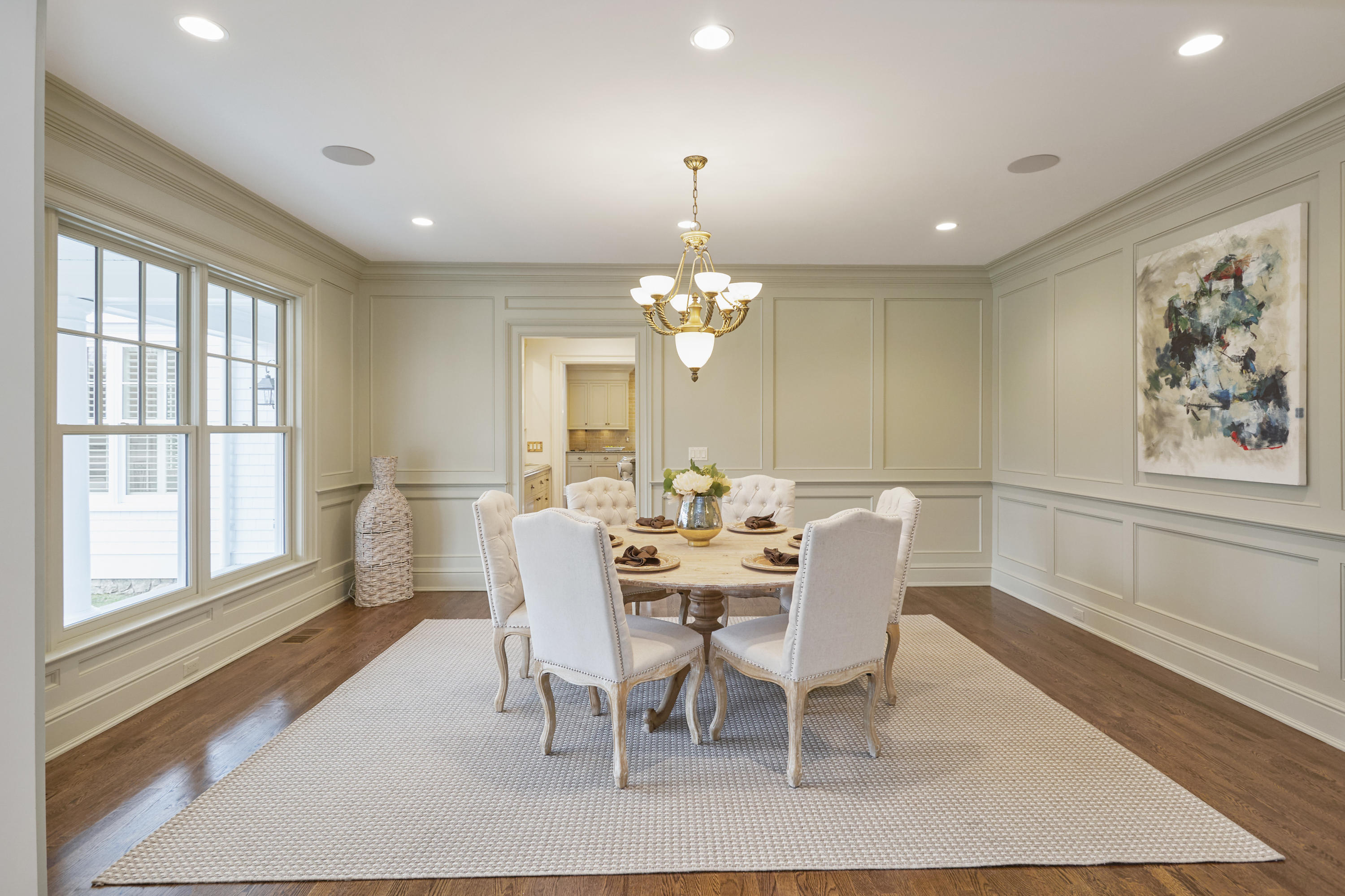 366 Brookside Road Darien, CT 06820 - Photo 11 of 40 a dining room with wooden floor a chandelier a glass table and chairs