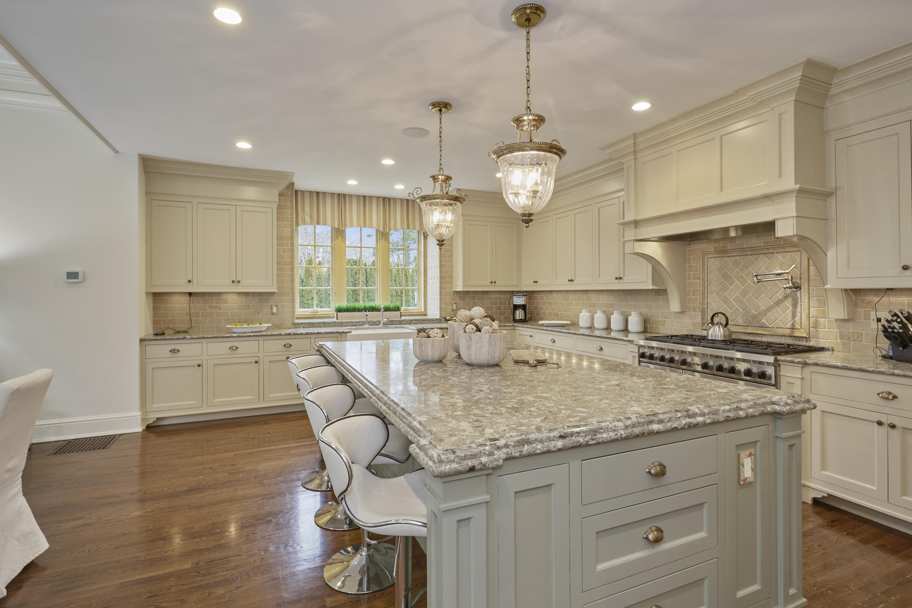366 Brookside Road Darien, CT 06820 - Photo 13 of 40 a kitchen with kitchen island granite countertop a stove a sink a center island and cabinets