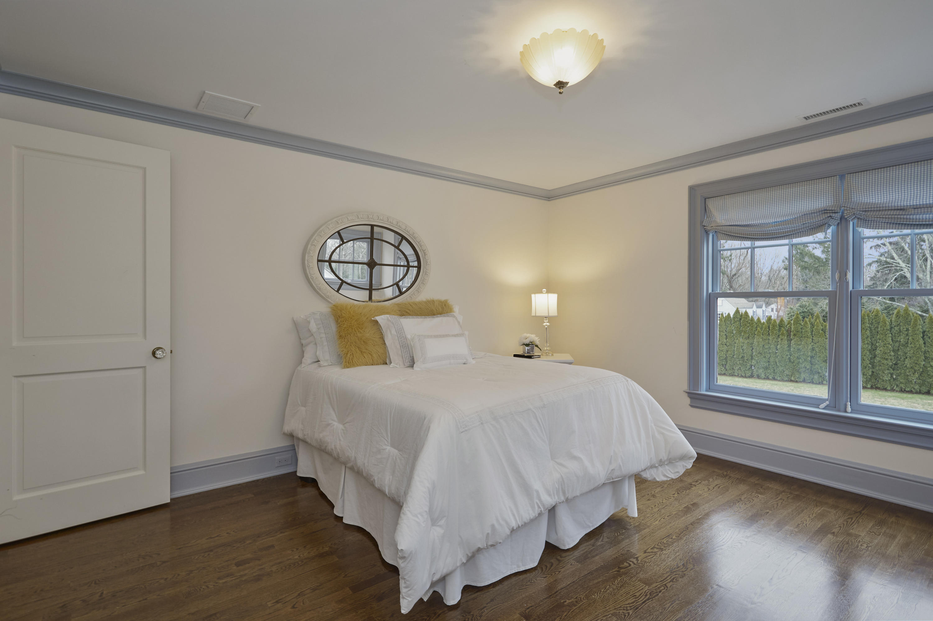 366 Brookside Road Darien, CT 06820 - Photo 24 of 40 a bedroom with a bed and window with wooden floor
