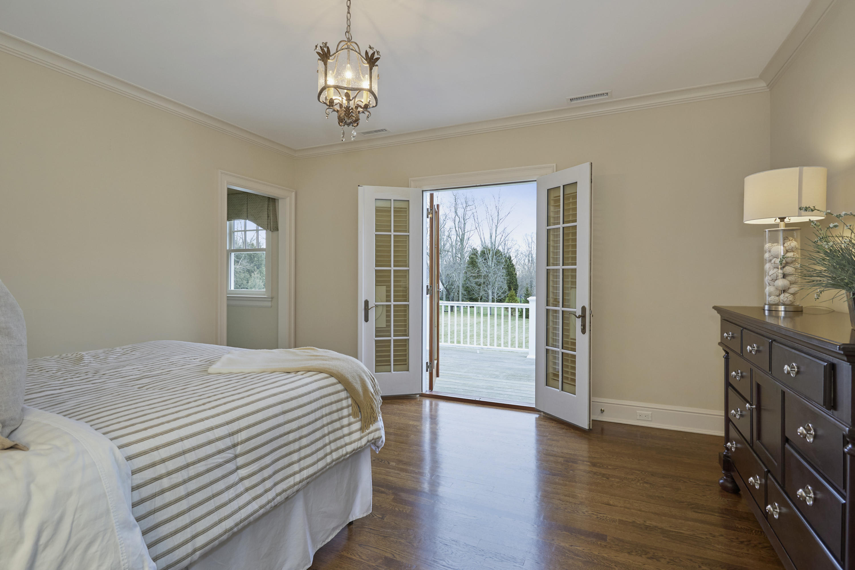 366 Brookside Road Darien, CT 06820 - Photo 25 of 40 a bedroom with a bed and wooden floor
