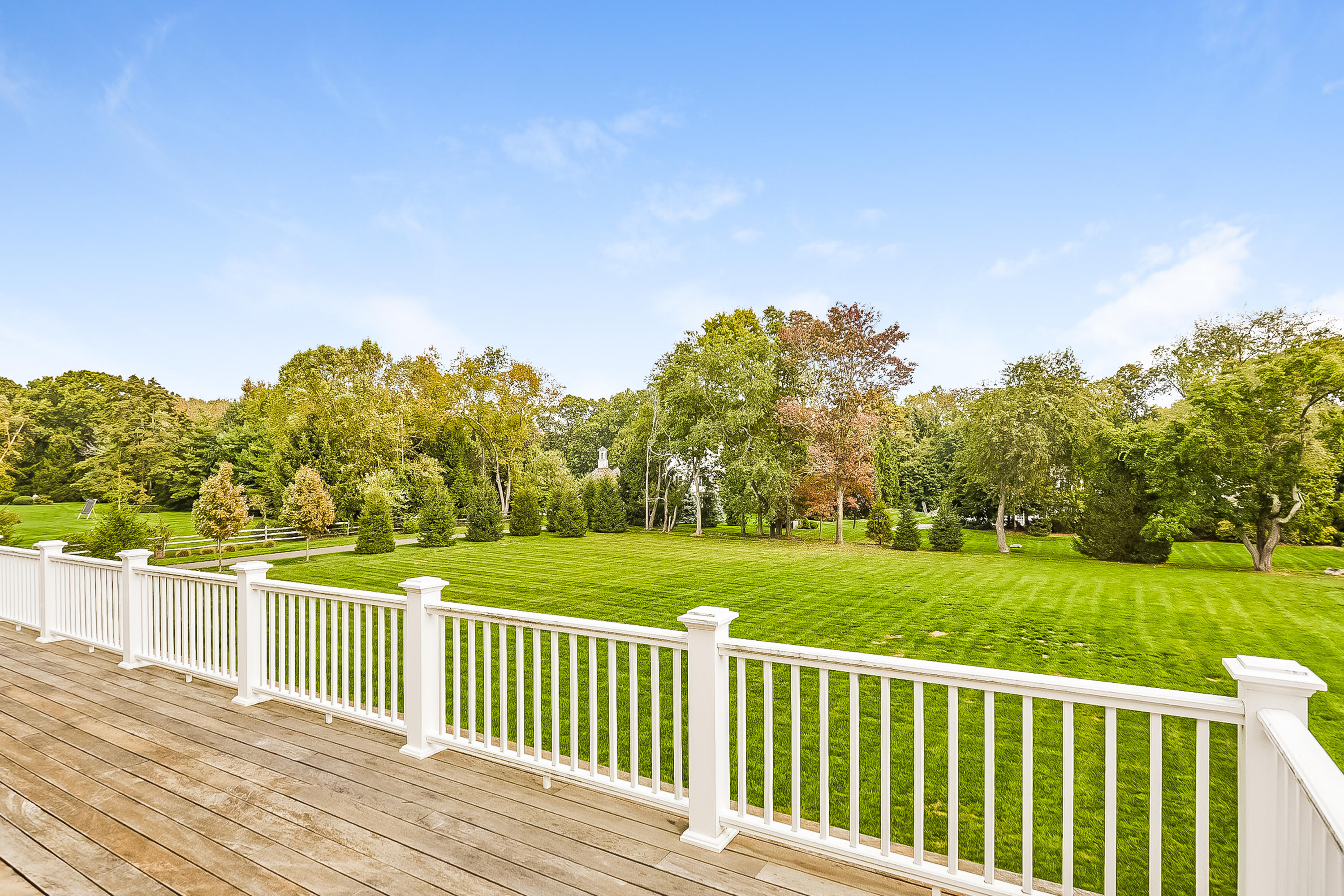 366 Brookside Road Darien, CT 06820 - Photo 28 of 40 a view of a wooden deck and a yard