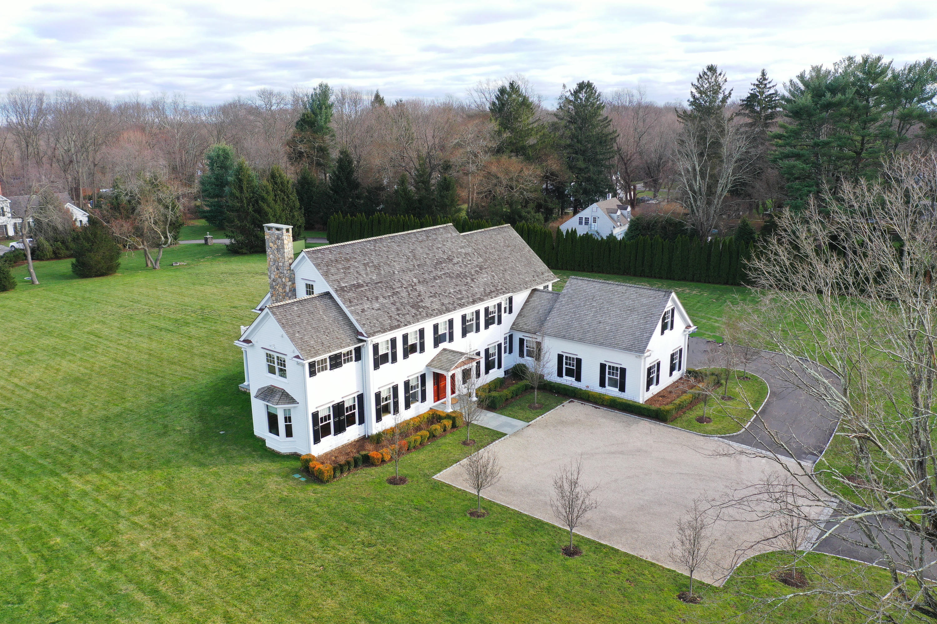 366 Brookside Road Darien, CT 06820 - Photo 4 of 40 a view of a house with a big yard and large trees