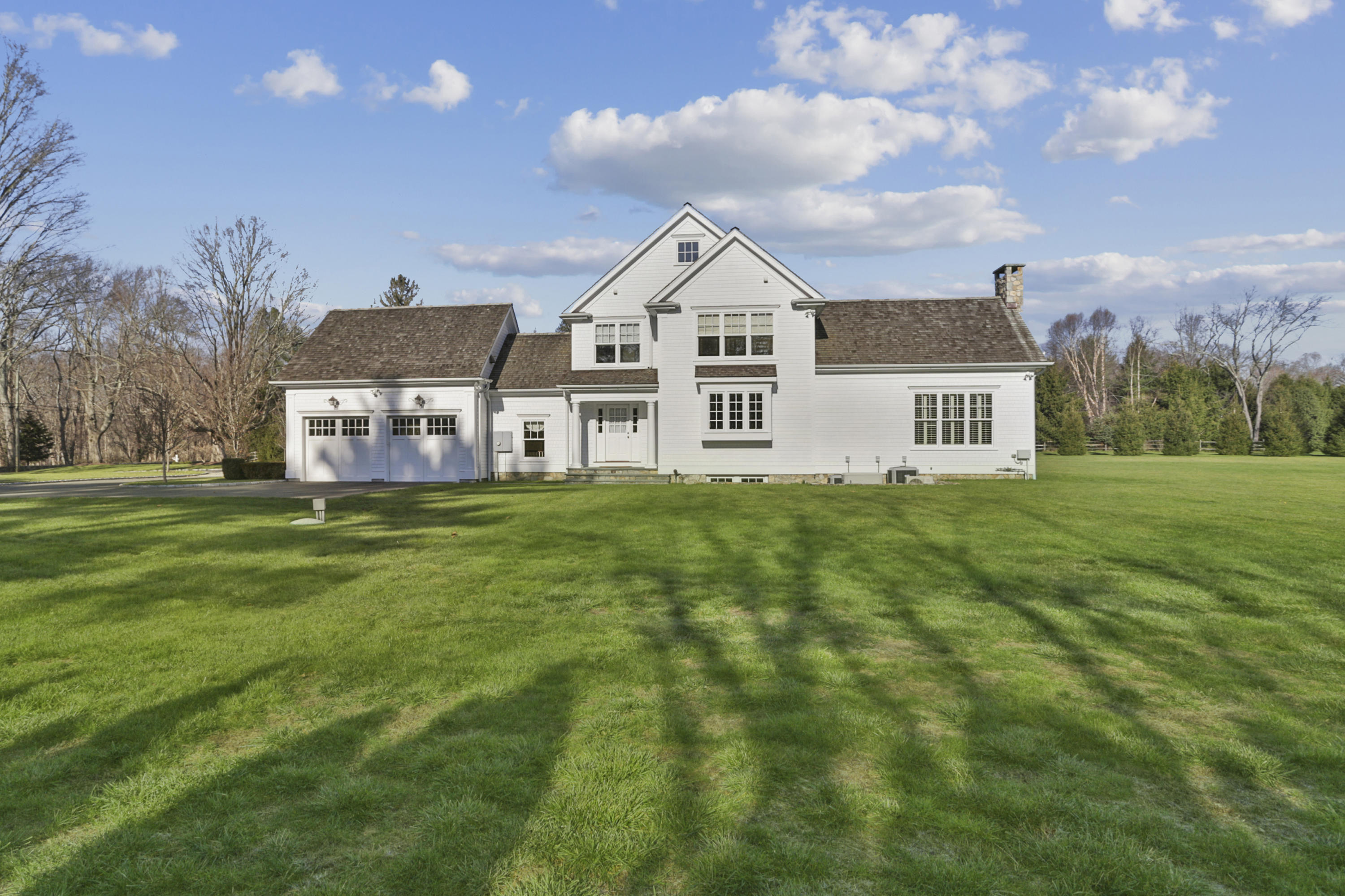 366 Brookside Road Darien, CT 06820 - Photo 34 of 40 a view of a house with a big yard and large trees