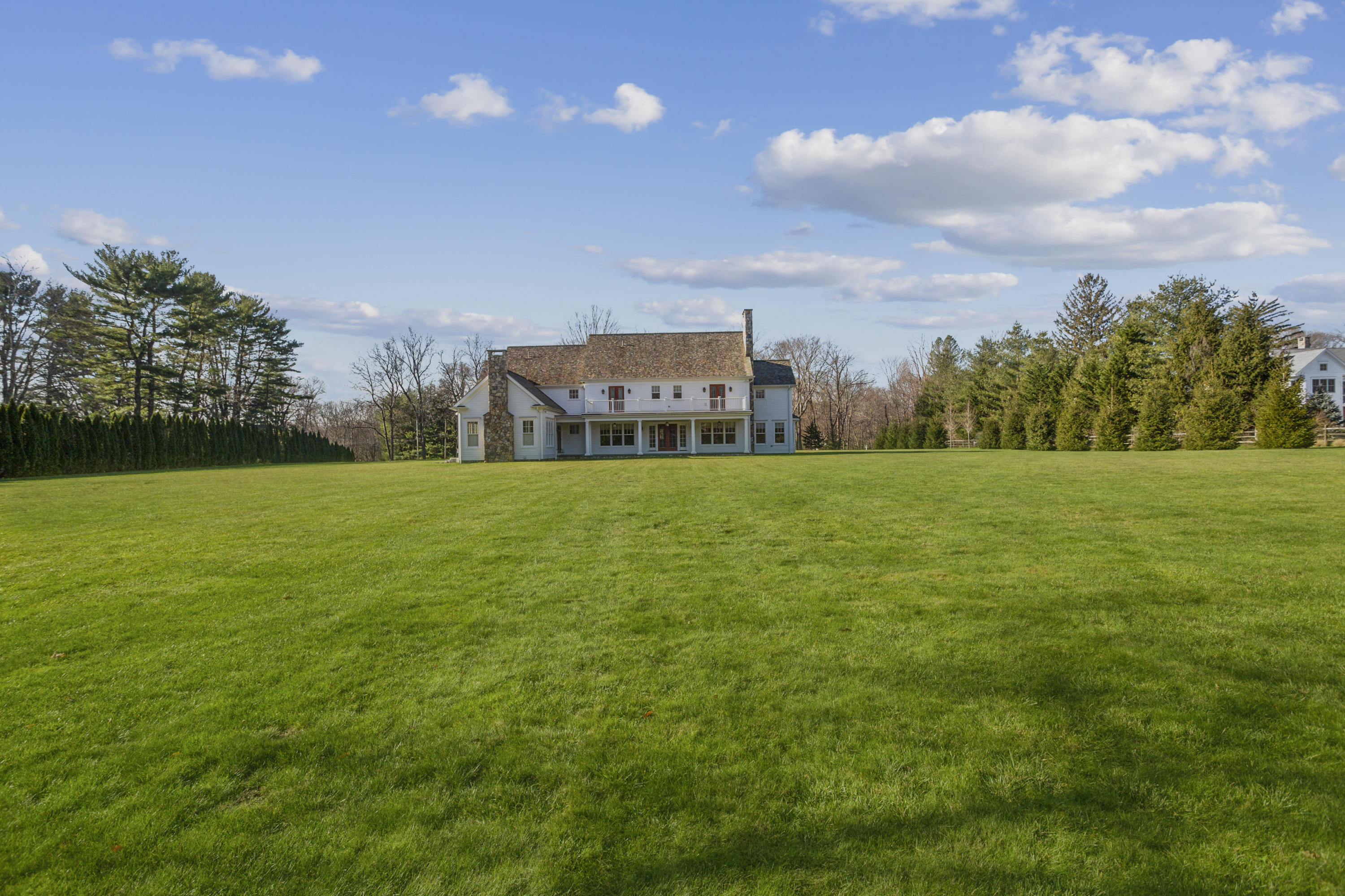366 Brookside Road Darien, CT 06820 - Photo 36 of 40 a view of a garden with a building in the background