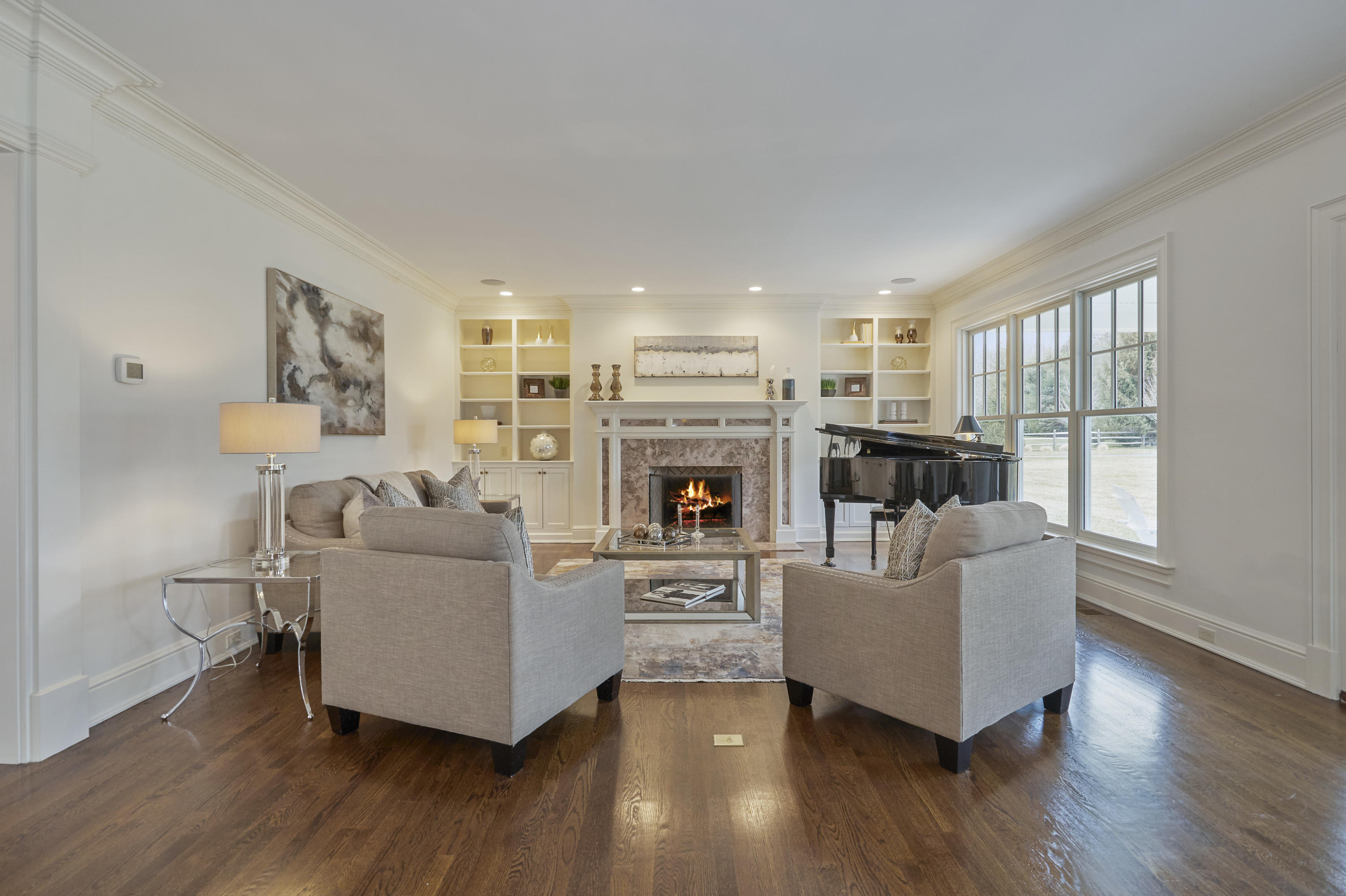 366 Brookside Road Darien, CT 06820 - Photo 8 of 40 a living room with furniture a fireplace and a large window