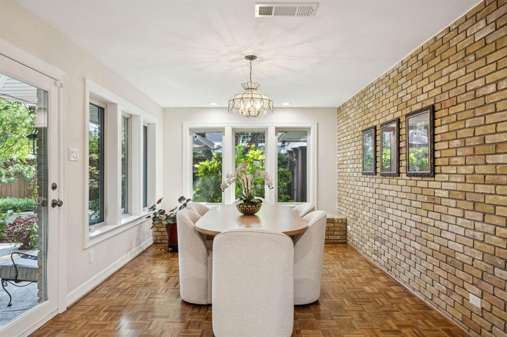 4708 Sugar Mill Road Dallas, TX 75244 - Photo 8 of 23 a dining room with furniture a chandelier and wooden floor