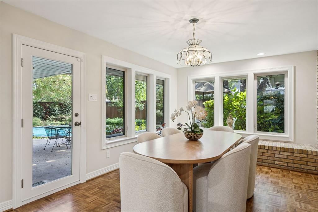 4708 Sugar Mill Road Dallas, TX 75244 - Photo 9 of 23 a dining room with wooden floor a chandelier