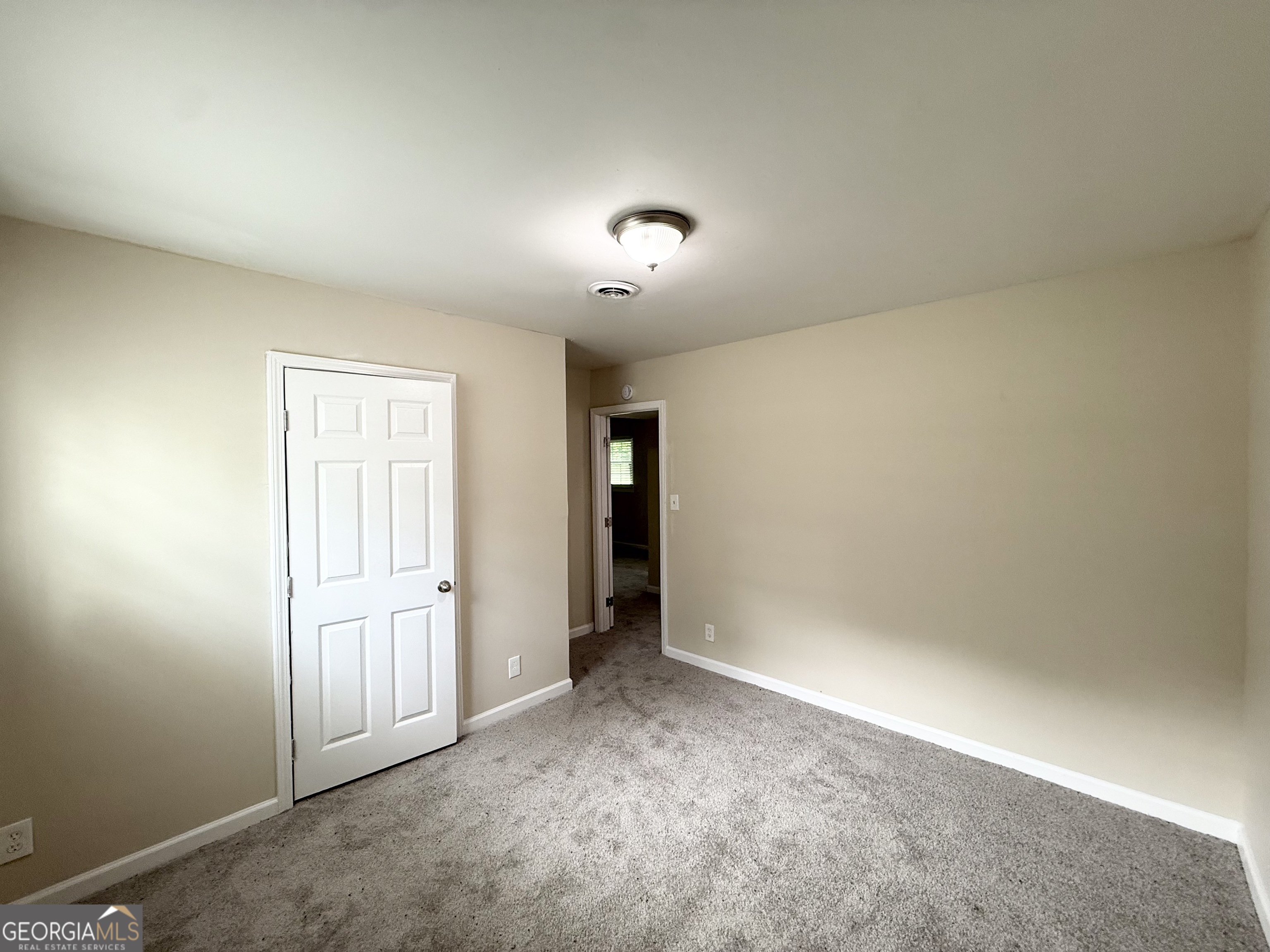 2782 Ocean Valley Road Atlanta, GA 30349 - Photo 23 of 27 an empty room with an entryway and fan