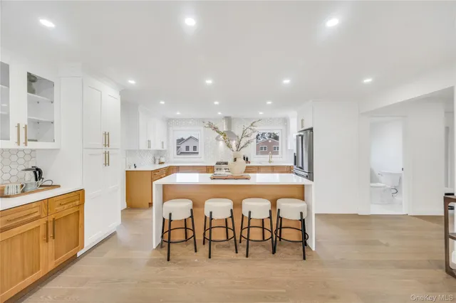 a large kitchen with kitchen island a sink table and chairs