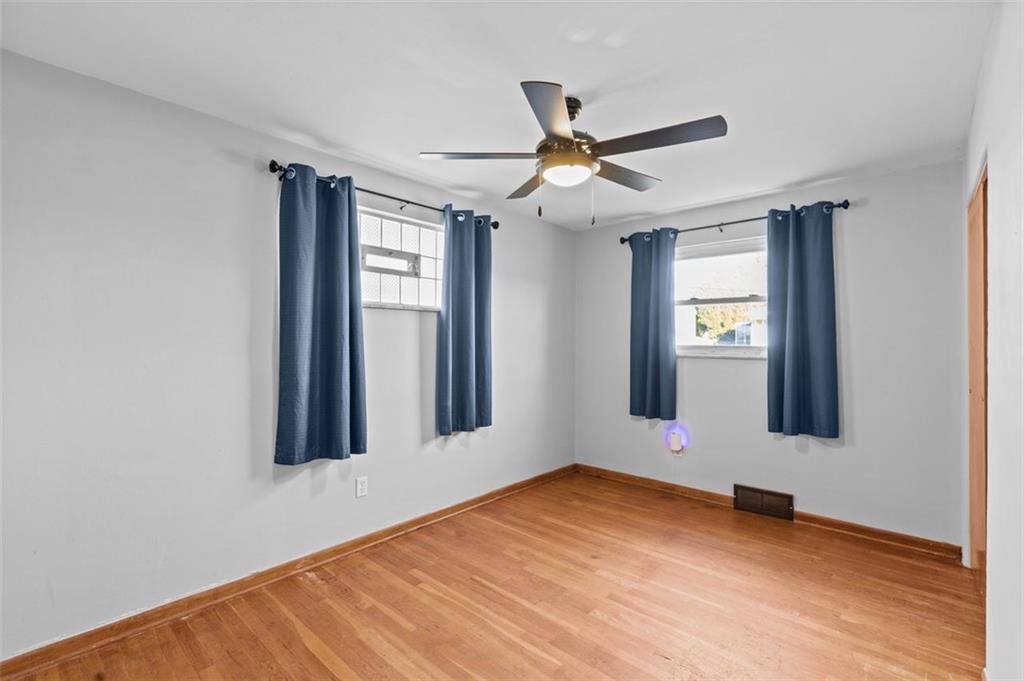 1210 Linden Street Cheswick, PA 15024 - Photo 13 of 31 a view of an empty room with window and wooden floor