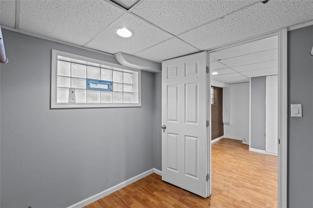 1210 Linden Street Cheswick, PA 15024 - Photo 21 of 31 a view of an empty room with wooden floor and a window