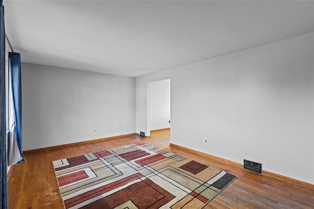 1210 Linden Street Cheswick, PA 15024 - Photo 4 of 31 an empty room with wooden floor