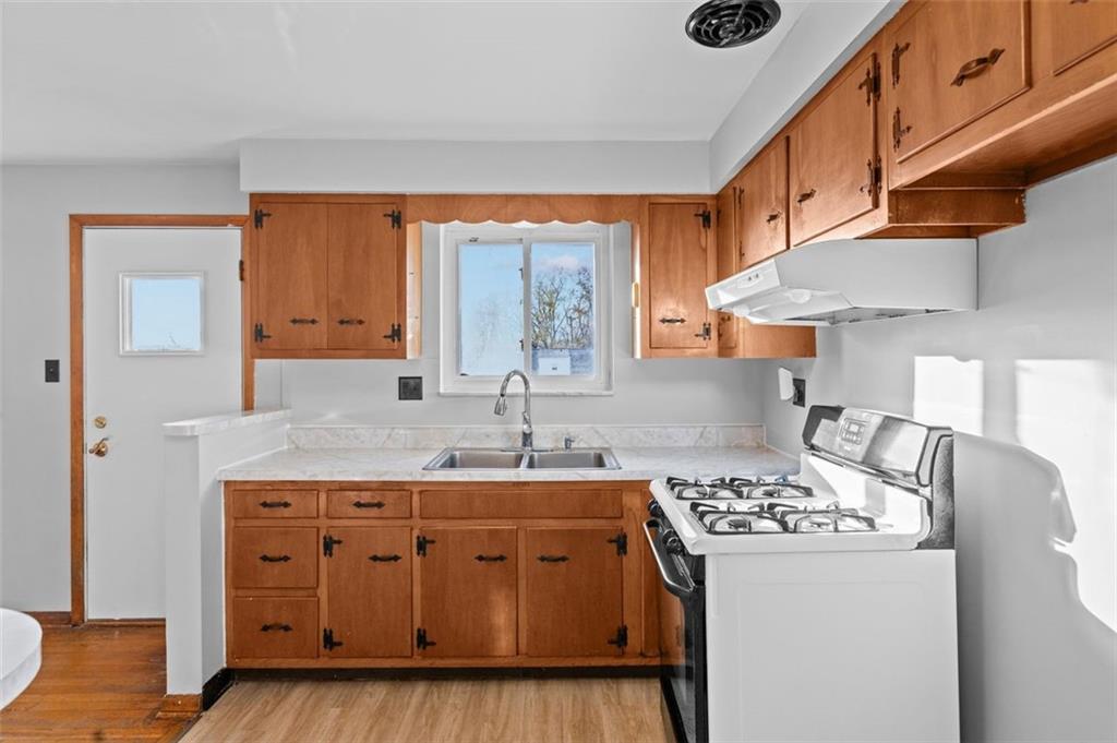 1210 Linden Street Cheswick, PA 15024 - Photo 9 of 31 a kitchen with stainless steel appliances granite countertop a sink stove and cabinets