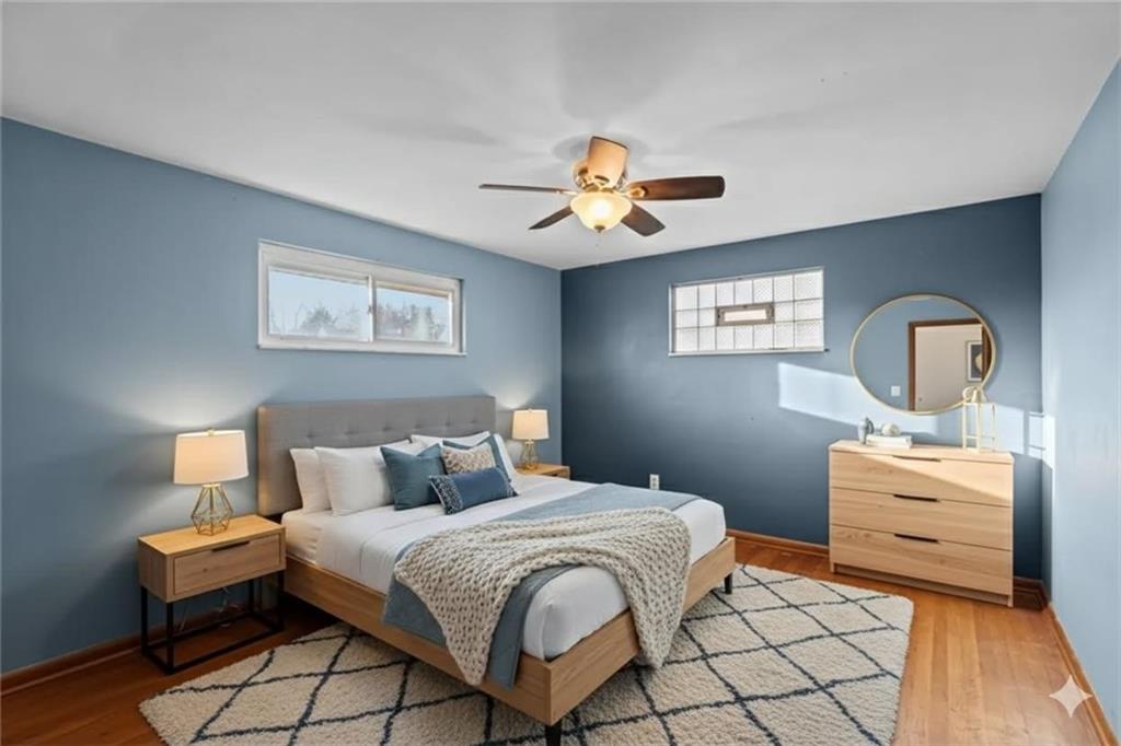 1210 Linden Street Cheswick, PA 15024 - Photo 10 of 31 a bedroom with a bed and a chandelier