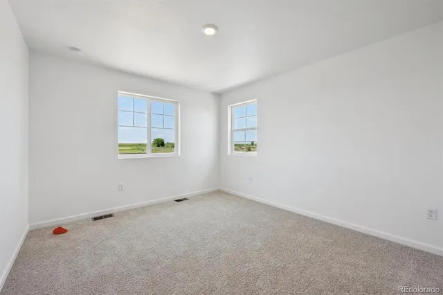 a view of small space with wooden floor and white walls