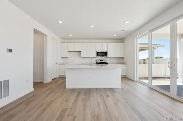 a view of kitchen with wooden floor