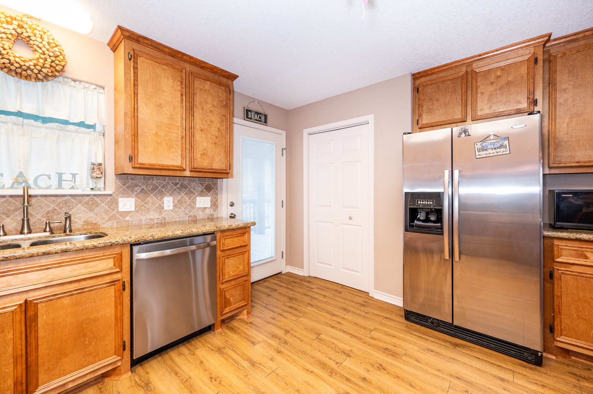 115 Albacore Street Sargent, TX 77414 - Photo 14 of 29 a kitchen with stainless steel appliances granite countertop a refrigerator and a stove top oven