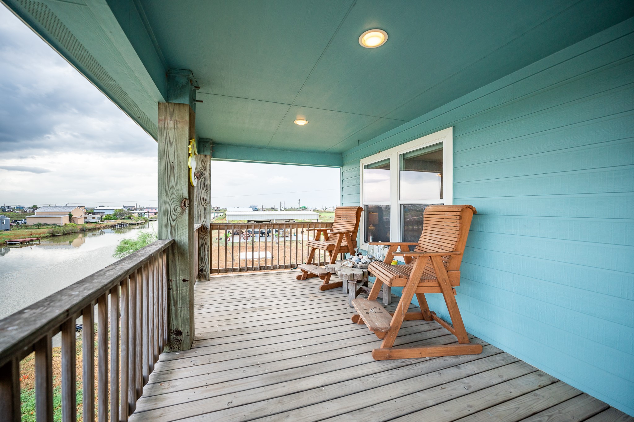115 Albacore Street Sargent, TX 77414 - Photo 17 of 29 a view of a balcony with chair and wooden floor