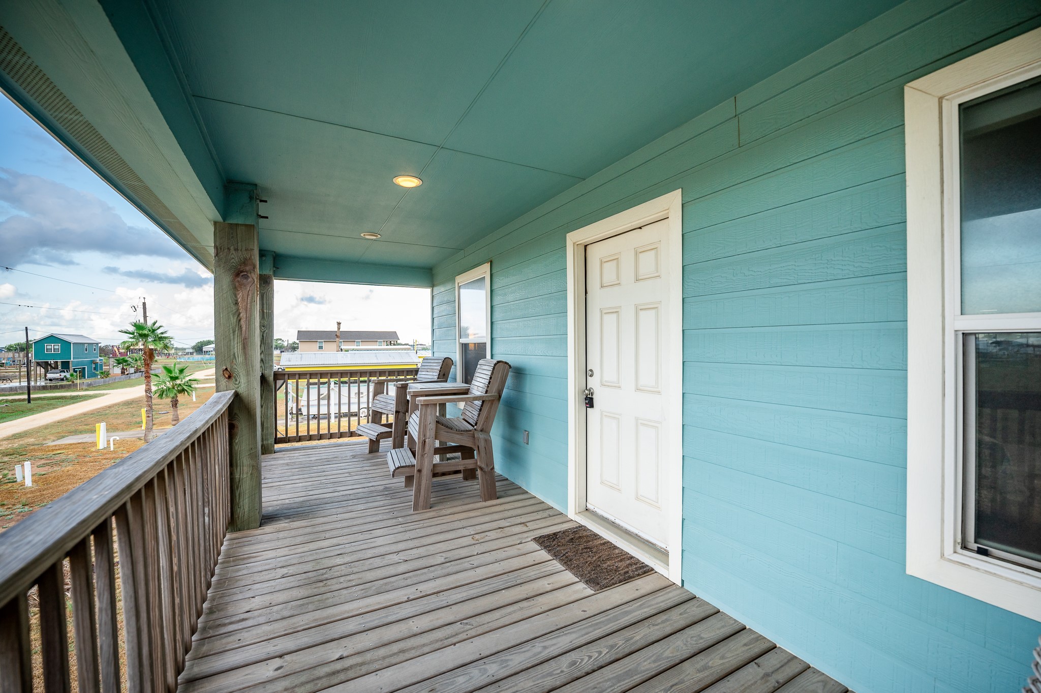 115 Albacore Street Sargent, TX 77414 - Photo 19 of 29 a view of a balcony with chairs and wooden floor