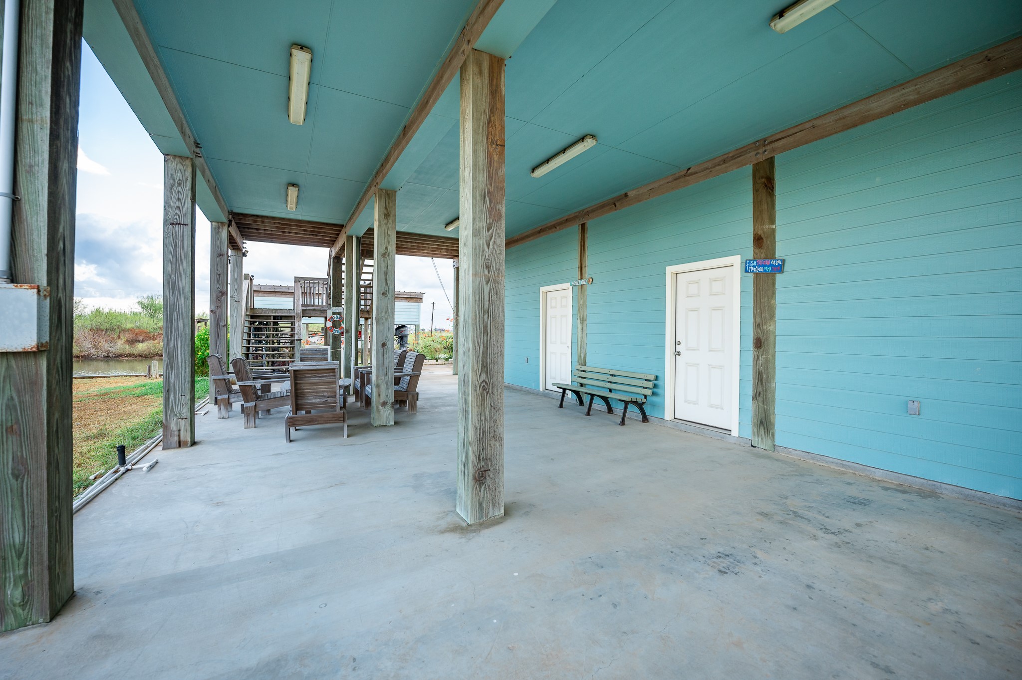 115 Albacore Street Sargent, TX 77414 - Photo 20 of 29 a view of a porch with chairs and backyard