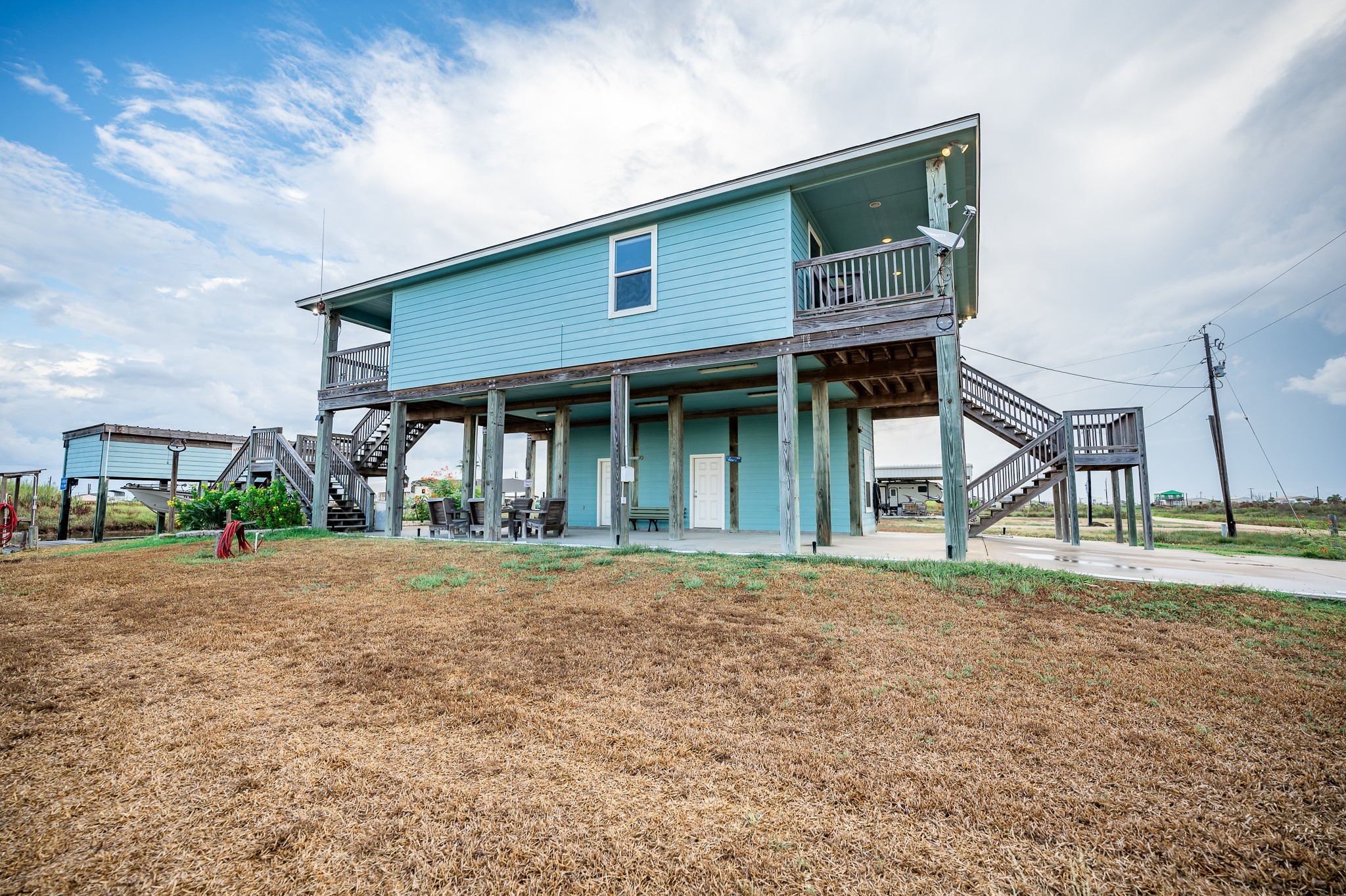 115 Albacore Street Sargent, TX 77414 - Photo 26 of 29 a front view of a house with a garden