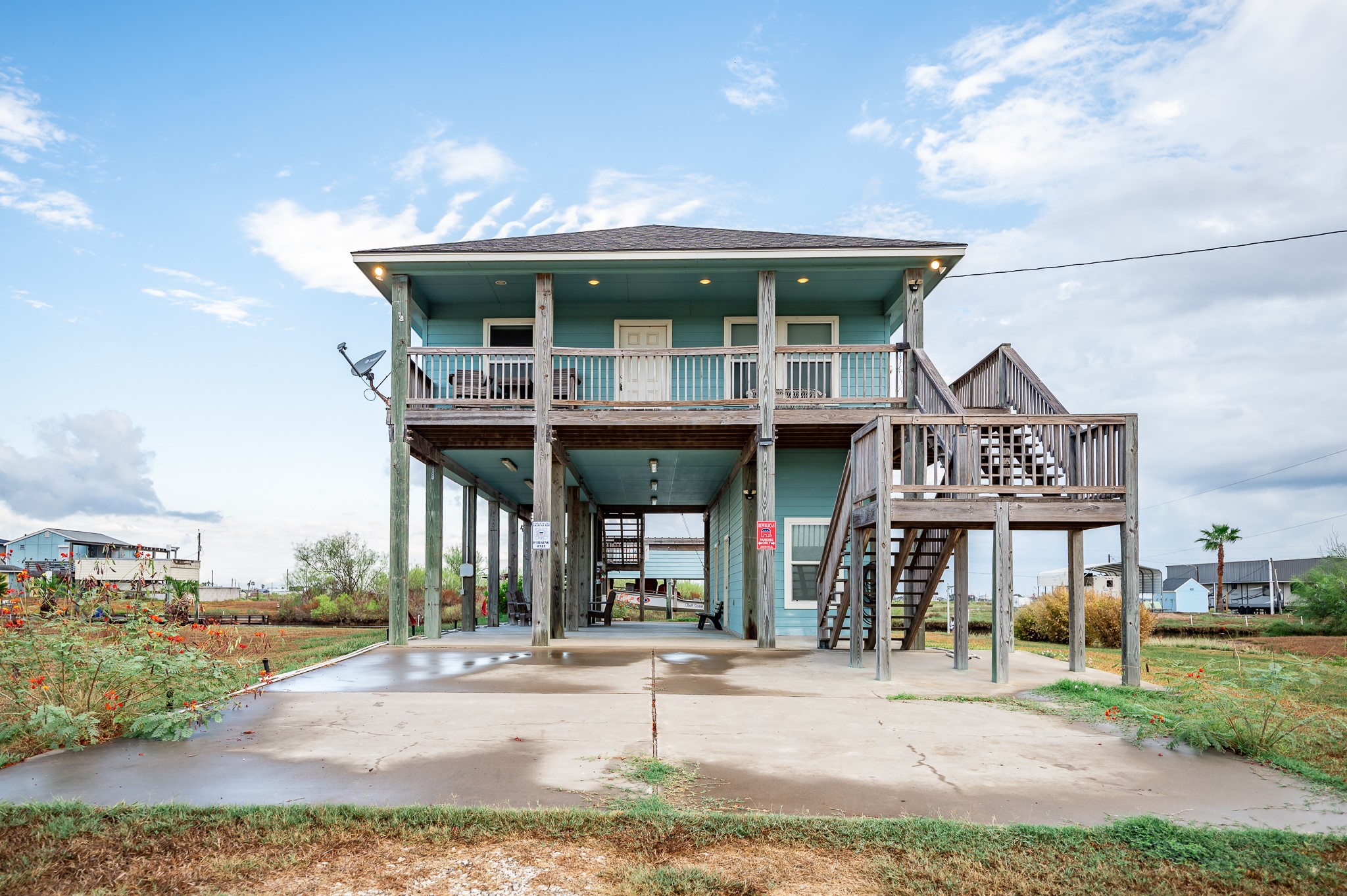 115 Albacore Street Sargent, TX 77414 - Photo 28 of 29 a patio with a table and chairs and potted plants