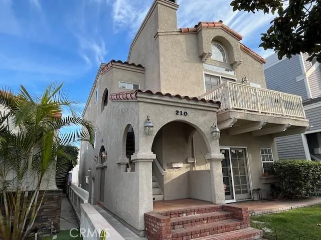 a view of a house with a floor to ceiling window and potted plants