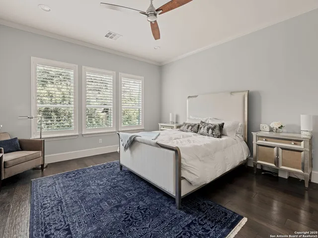 a view of a bedroom with furniture and windows