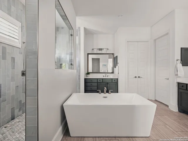 a bathroom with a sink a mirror and shower
