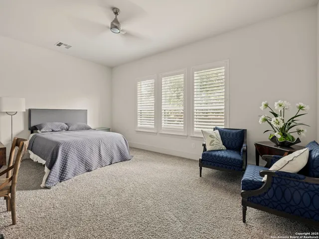 a bedroom with a large bed and a couch