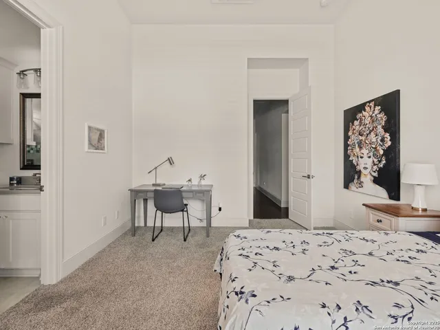 a bedroom with a bed and a table