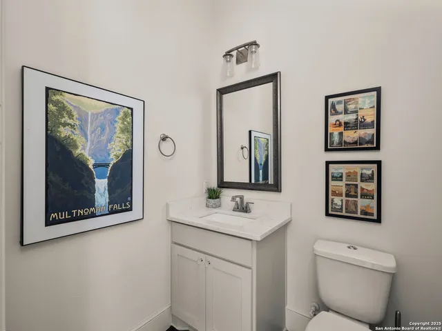 a bathroom with a toilet a sink and a mirror