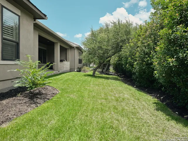 a view of a house with a backyard and garden