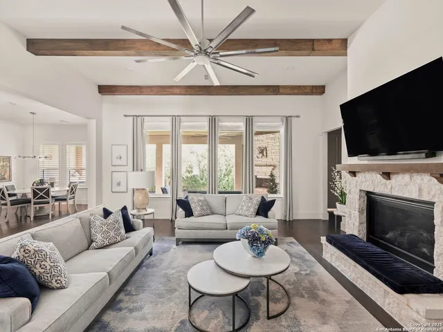 a living room with furniture a flat screen tv and a fireplace