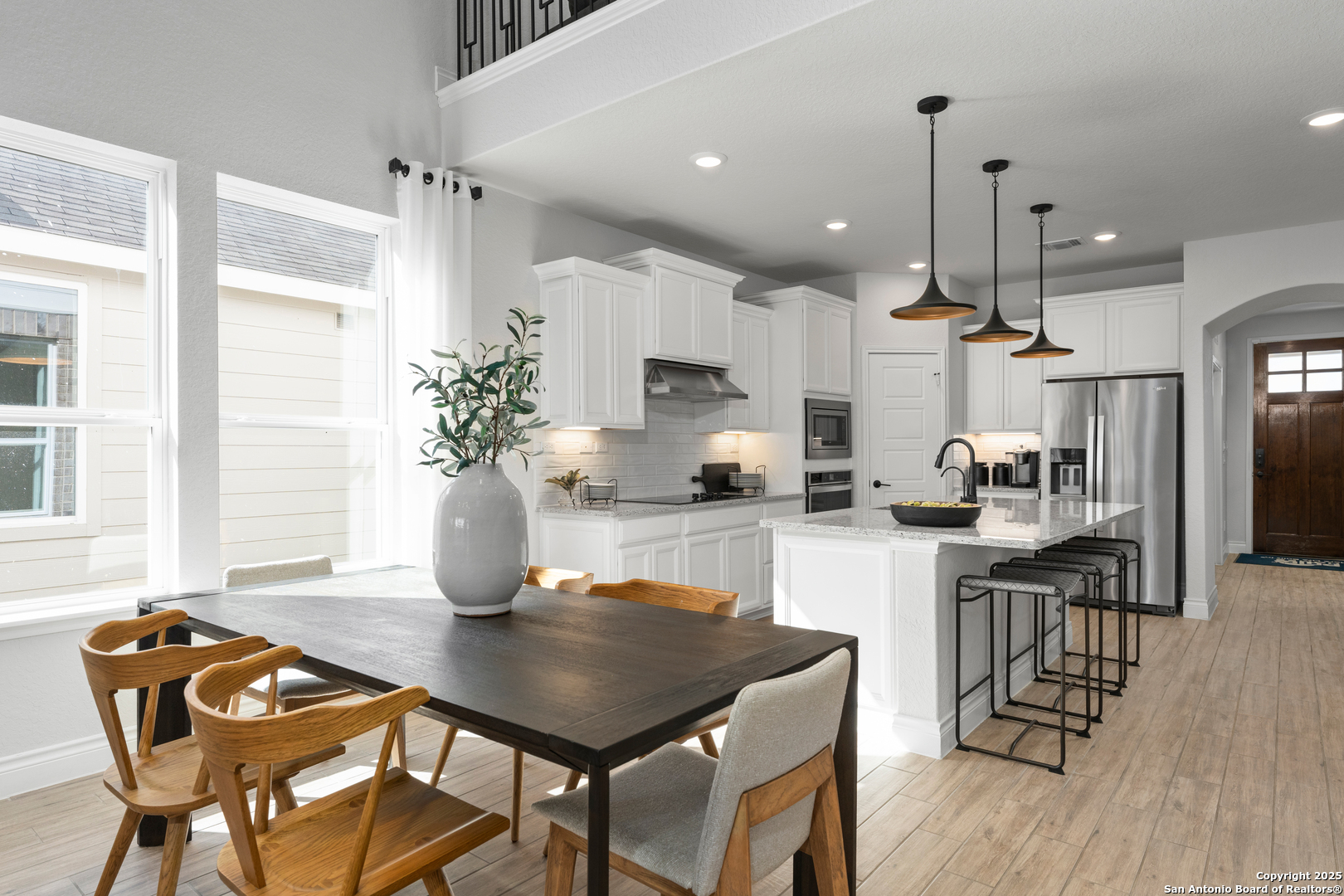 4036 Paddock Trail Seguin, TX 78155 - Photo 10 of 15 a kitchen with a table chairs refrigerator and microwave