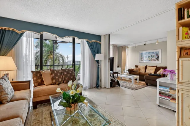 a living room with furniture and a floor to ceiling window
