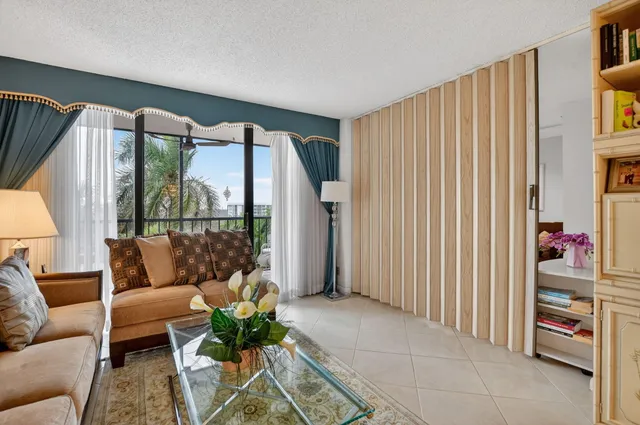 a living room with furniture and a window with garden view