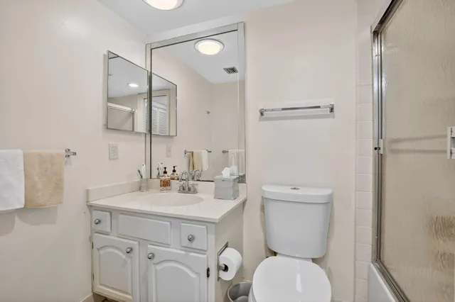 a white toilet sitting next to a bathroom sink