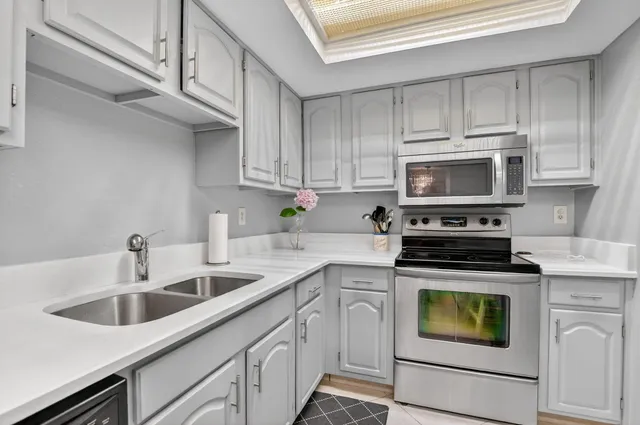 a kitchen with cabinets appliances and a sink