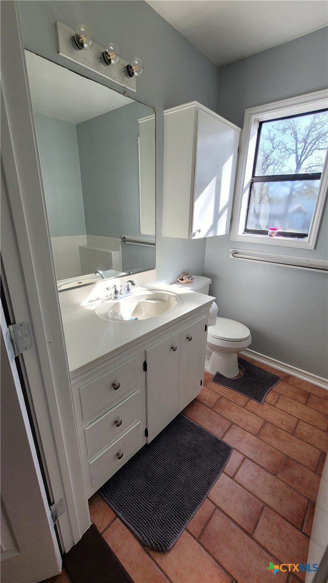127-129 McAdams Road Goliad, TX 77963 - Photo 29 of 33 a bathroom with a double vanity sink toilet and a mirror