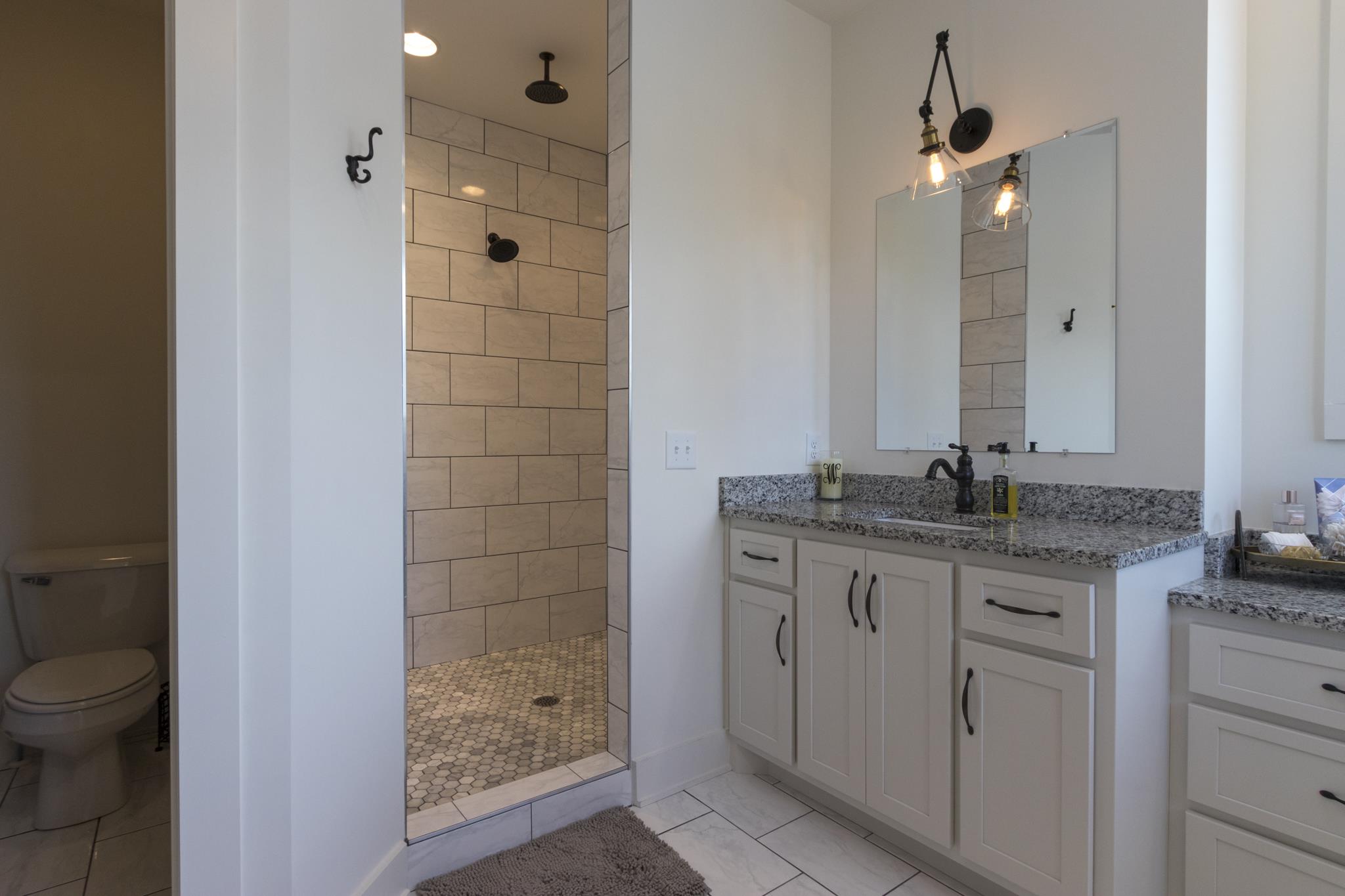 1024 Franklin Road Gallatin, TN 37066 - Photo 12 of 28 a bathroom with a granite countertop sink a toilet and shower