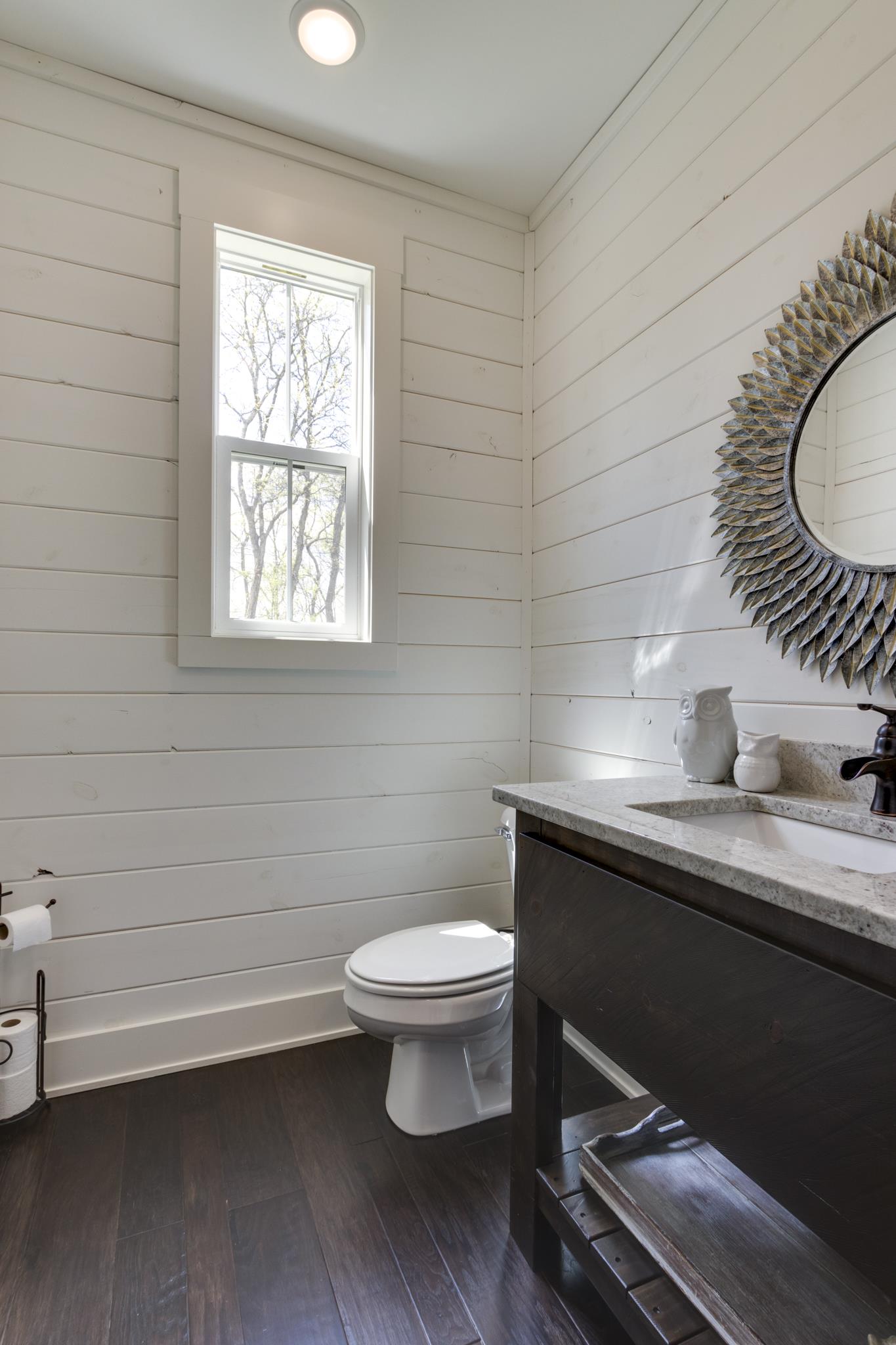 1024 Franklin Road Gallatin, TN 37066 - Photo 15 of 28 a bathroom with a toilet a sink and mirror
