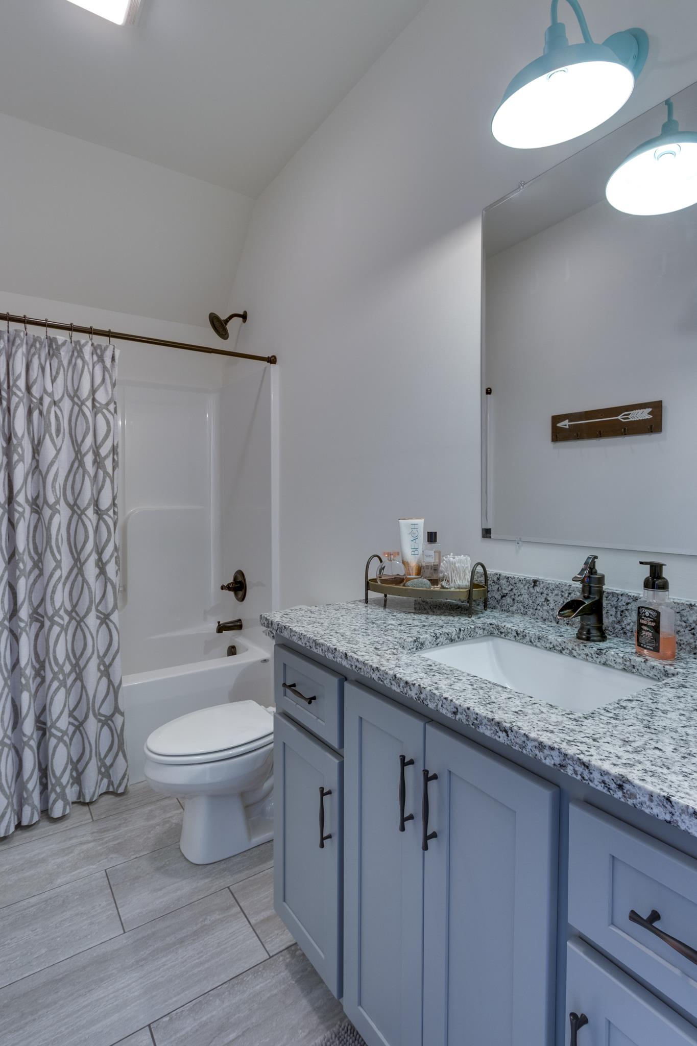 1024 Franklin Road Gallatin, TN 37066 - Photo 21 of 28 a bathroom with a granite countertop sink and a mirror