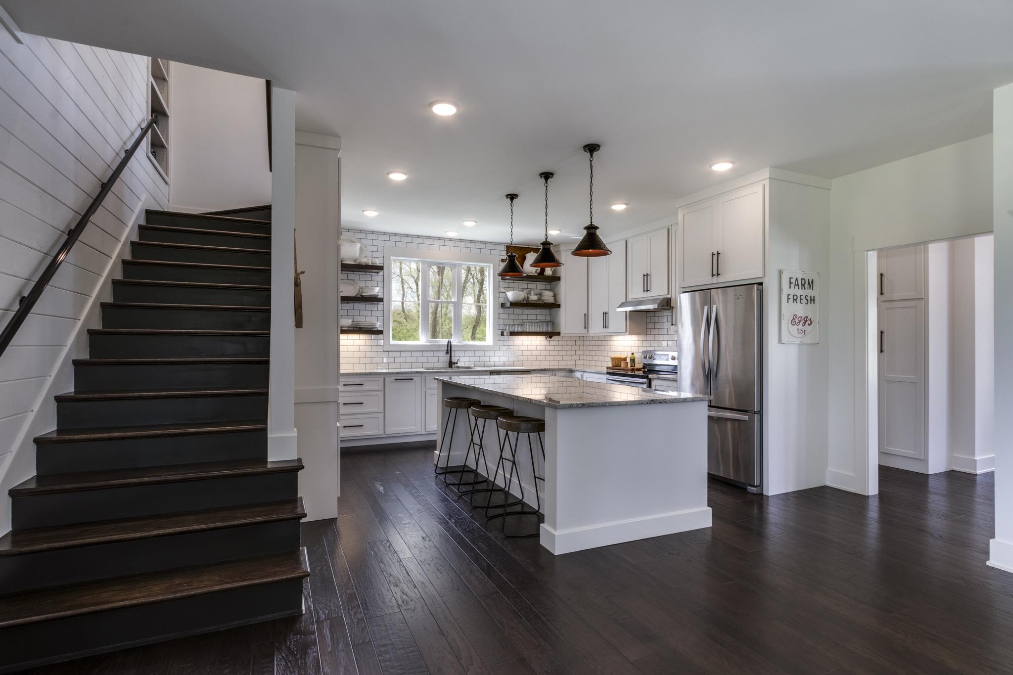 1024 Franklin Road Gallatin, TN 37066 - Photo 5 of 28 a kitchen with stainless steel appliances kitchen island wooden floors wooden cabinets and entryway