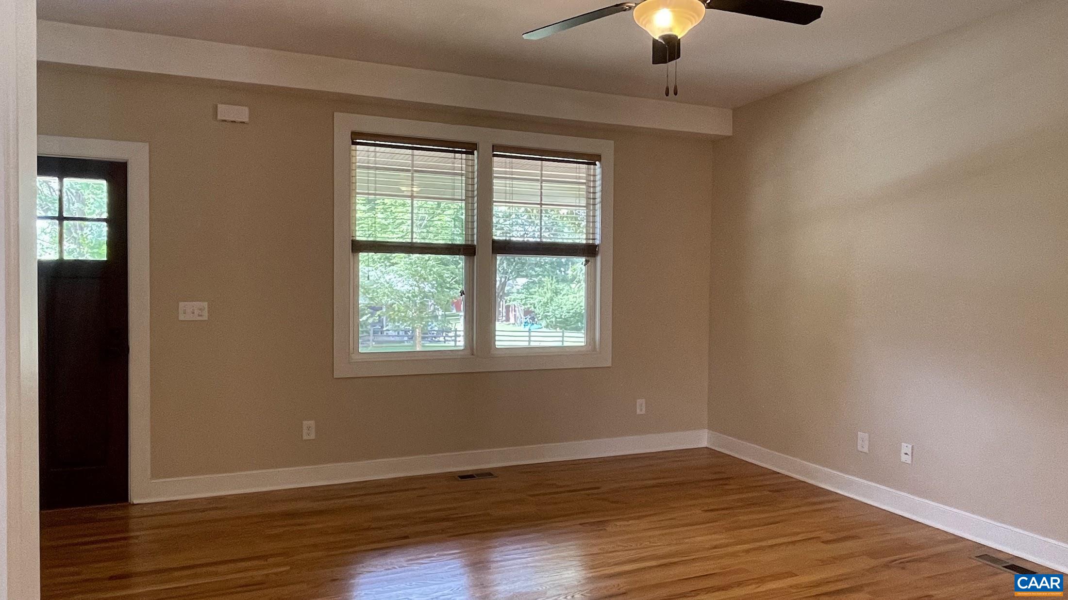 200 Harris Road Charlottesville, VA 22903 - Photo 7 of 28 a view of an empty room with window and wooden floor