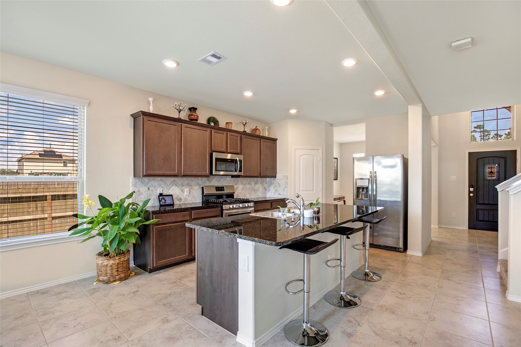 4519 Whitehaven Ridge Way Porter, TX 77365 - Photo 15 of 35 a kitchen with a sink and refrigerator