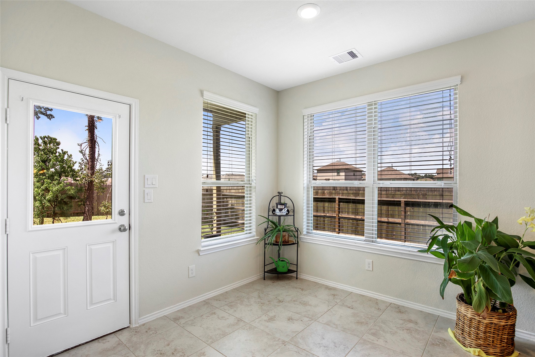 4519 Whitehaven Ridge Way Porter, TX 77365 - Photo 19 of 35 a view of an empty room with a window and potted plants