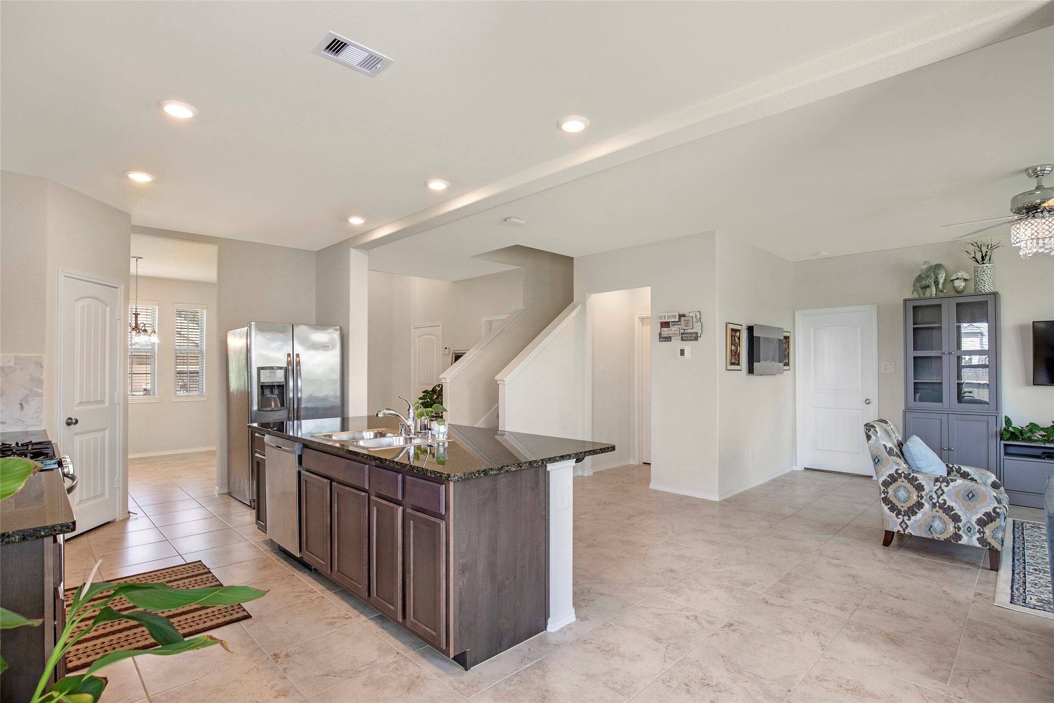 4519 Whitehaven Ridge Way Porter, TX 77365 - Photo 20 of 35 a kitchen with stainless steel appliances kitchen island granite countertop a refrigerator and a sink