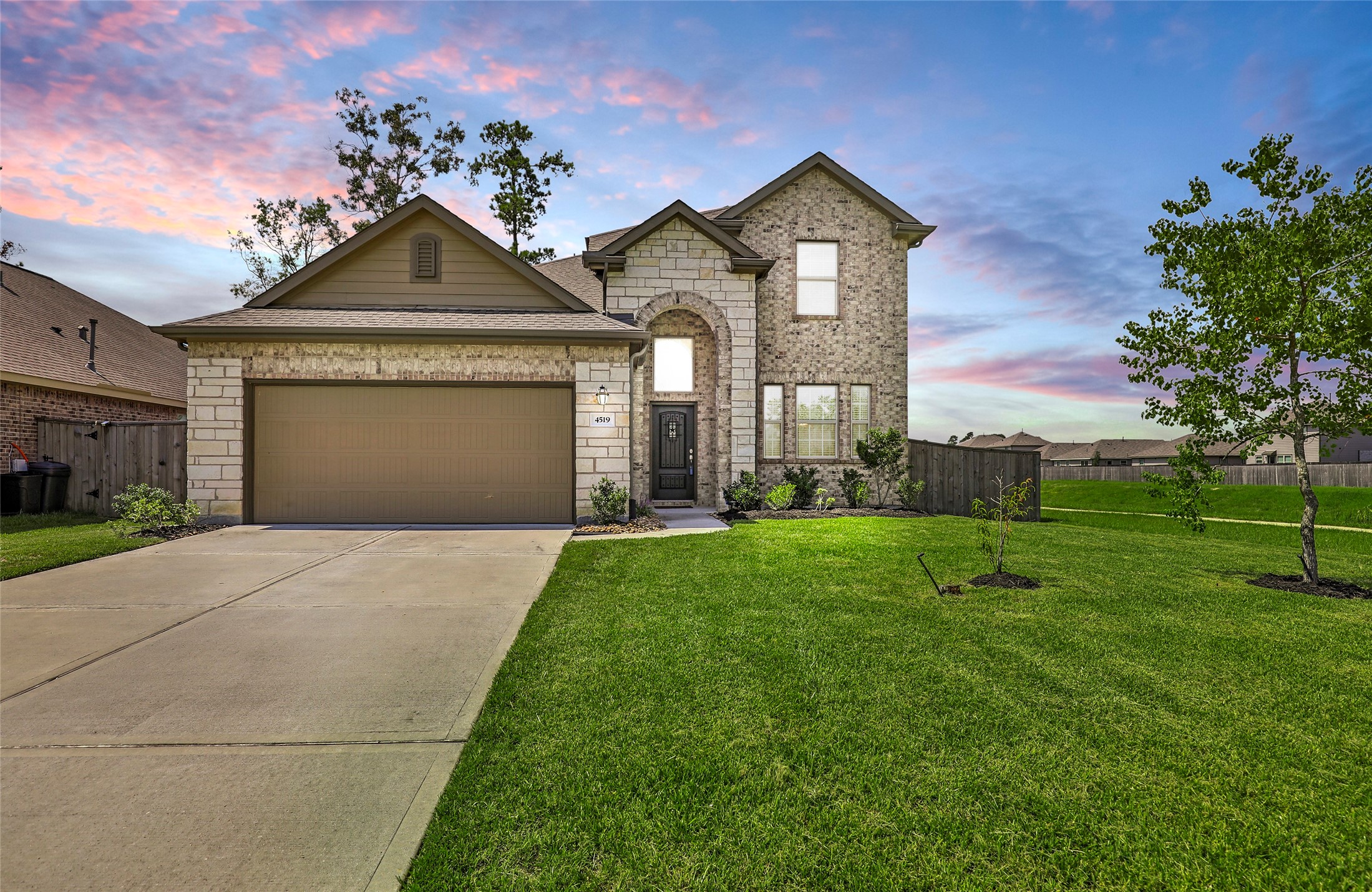 4519 Whitehaven Ridge Way Porter, TX 77365 - Photo 2 of 35 a front view of a house with a yard and garage