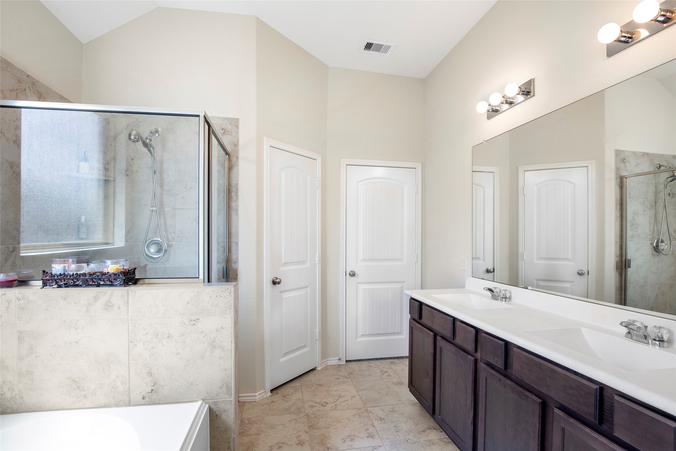 4519 Whitehaven Ridge Way Porter, TX 77365 - Photo 27 of 35 a bathroom with a double vanity sink a mirror and a shower